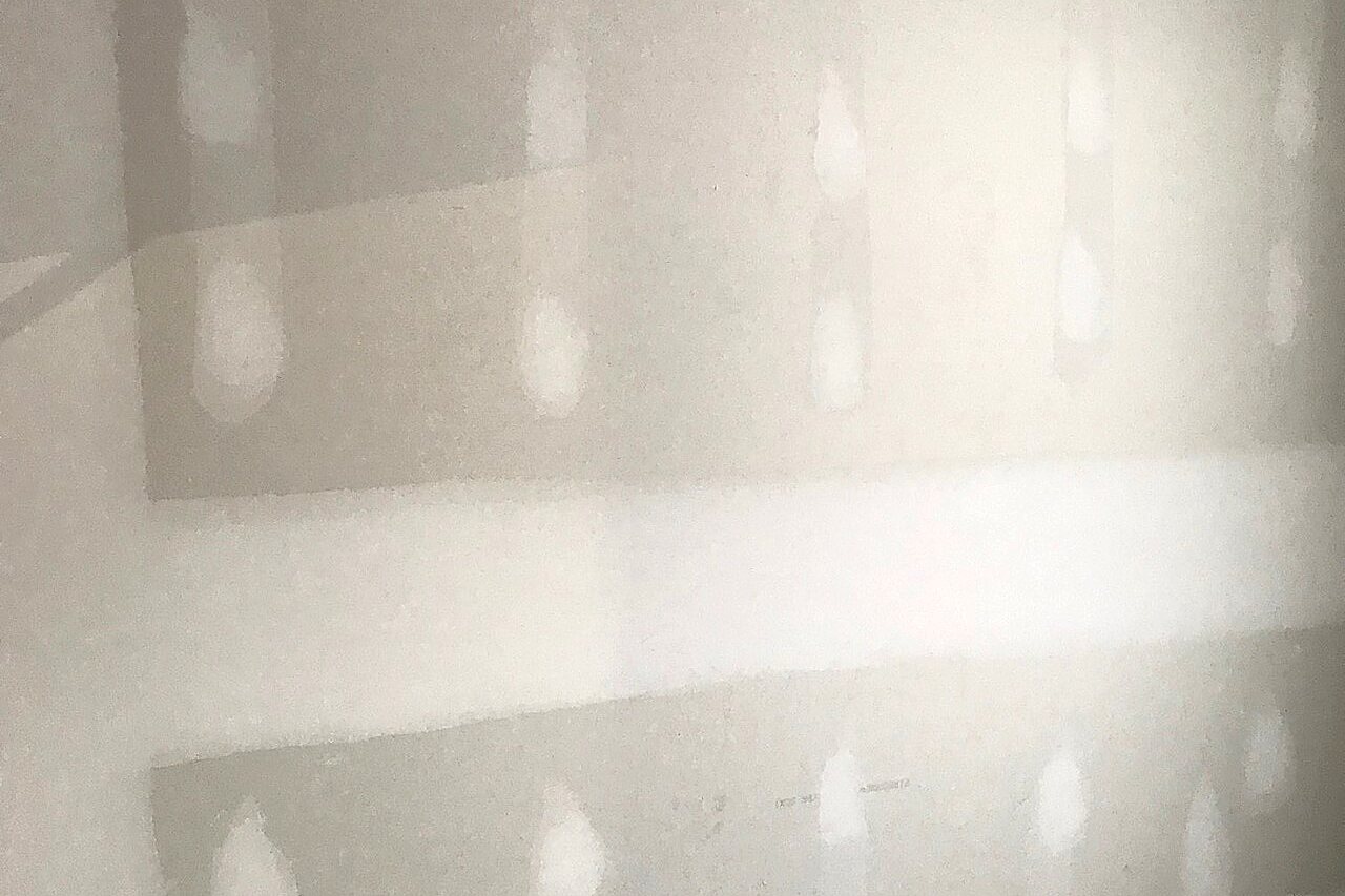 Wall with wide, feathered and sanded compound over every seam